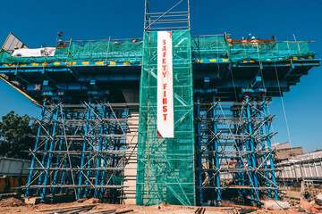 A Building Under Construction with safety first banner
