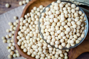 Top view of dry organic soybean seed pile in glass bowl in dark tone. For healthy and clean food ingredient or agricultural product concept