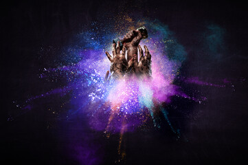 Hands holding champion cup on colourful splashes background. Mixed media