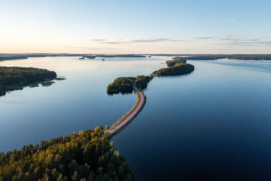 Pulkkilanharju ridge road and calm P&auml;ij&auml;nne lake in summer in Finland.