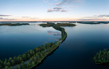 Naklejka na ściany i meble Aerial drone view of Punkaharju nature reserve and its famous ridge road in Savonlinna, Finland.