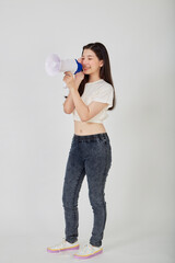 young pretty Asian woman holding megaphone