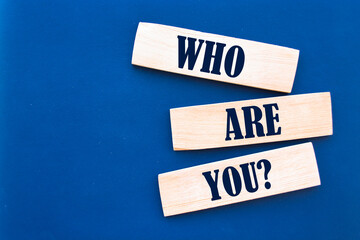Who are you? question written wooden blocks.