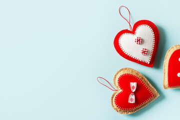 Handmade red textile heart on blue background