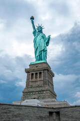 Fototapeta na wymiar Statue of Liberty against cloudy sky