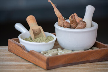 Herbal extracts powder in white cup.