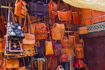 The leather handbags in the market place in the medina of Marrakesh on a sunny day. Morocco.