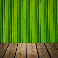 The background is blank wooden boards and a textured striped wall with gradient lighting and...