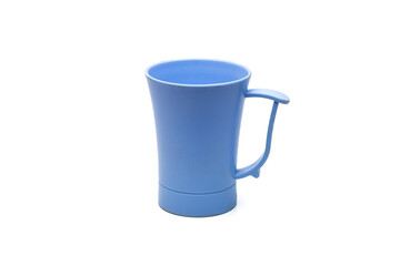 Blue old plastic tea mug close up on isolated white background