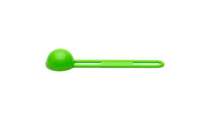 Isolated green measuring plastic spoon on white background