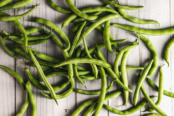 Fresh green beans on white wood