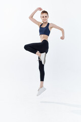 cheerful sportive woman with her leg raised workout lifestyle jumping