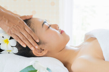 Obraz na płótnie Canvas Young woman enjoying massage in spa salon
