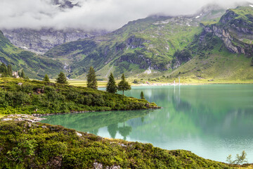 Tranquil landscape on the mountain lake Truebsee with turquois water in sommer day