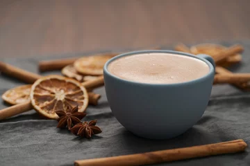 Fotobehang Hot chocolate in a blue cup with natural christmas decorations © GCapture