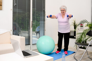 portrait of an active and dynamic senior woman doing sport fitness at home