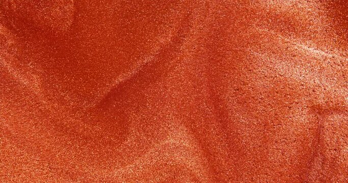 The Red glittering water slowly flows into beautiful abstract patterns