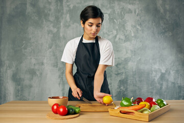 housewife on the kitchen cutting vegetables isolated background