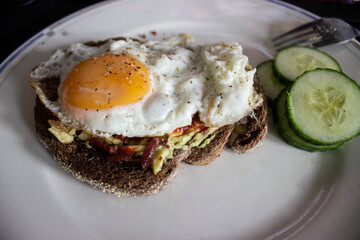 Egg and Avocado on toast with cucumber on the side