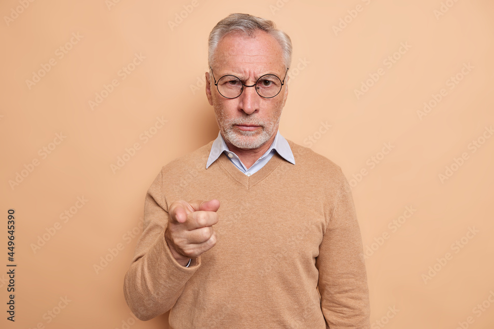 Sticker serious strict bearded elderly man points index finger at camera picks you being self assured wears 