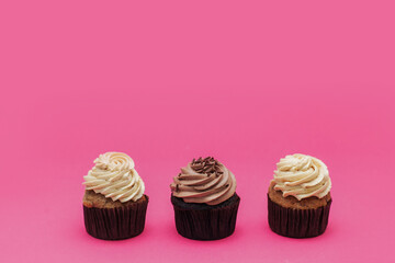 three cakes on a bright pink background