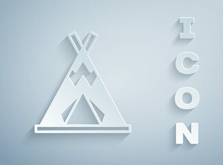 Paper cut Traditional indian teepee or wigwam icon isolated on grey background. Indian tent. Paper art style. Vector © Kostiantyn