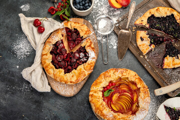 Homemade gallete variety with different filling on dark gray background.