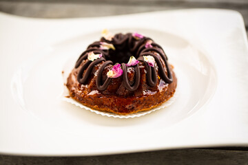 Mini bundt cake with chocolate on a white plate