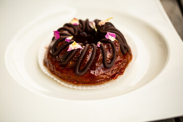 Mini bundt cake with chocolate on a white plate