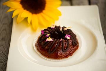 Mini bundt cake with chocolate on a white plate