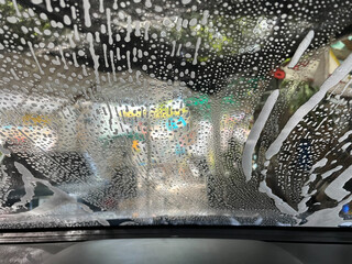 Bubble water on the windshield for cleaning.