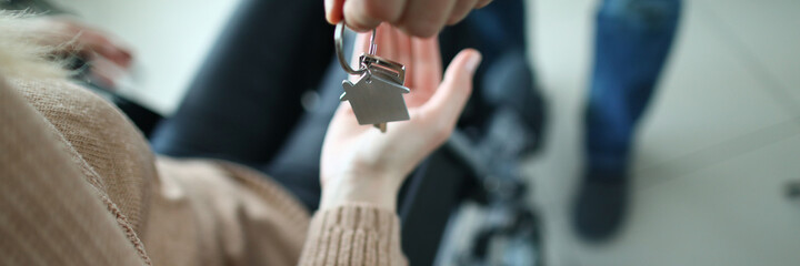 Woman in wheelchair is given keys to apartment