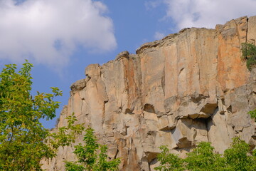 Huge stones  with blue sky background and behind trees in ihlara valley