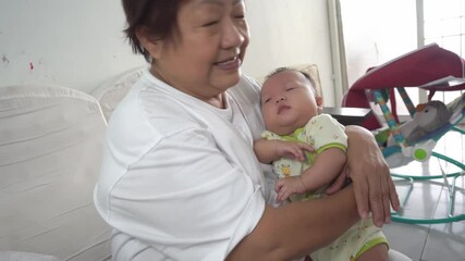 Grandmother burp baby boy after drink the milk