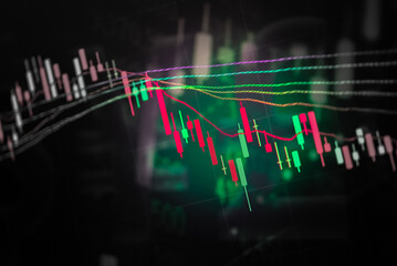 Abstract financial trading graphs and digital number of foreign exchange market trading on monitor. Background of gold and blue digital chart to represent stock market trend.