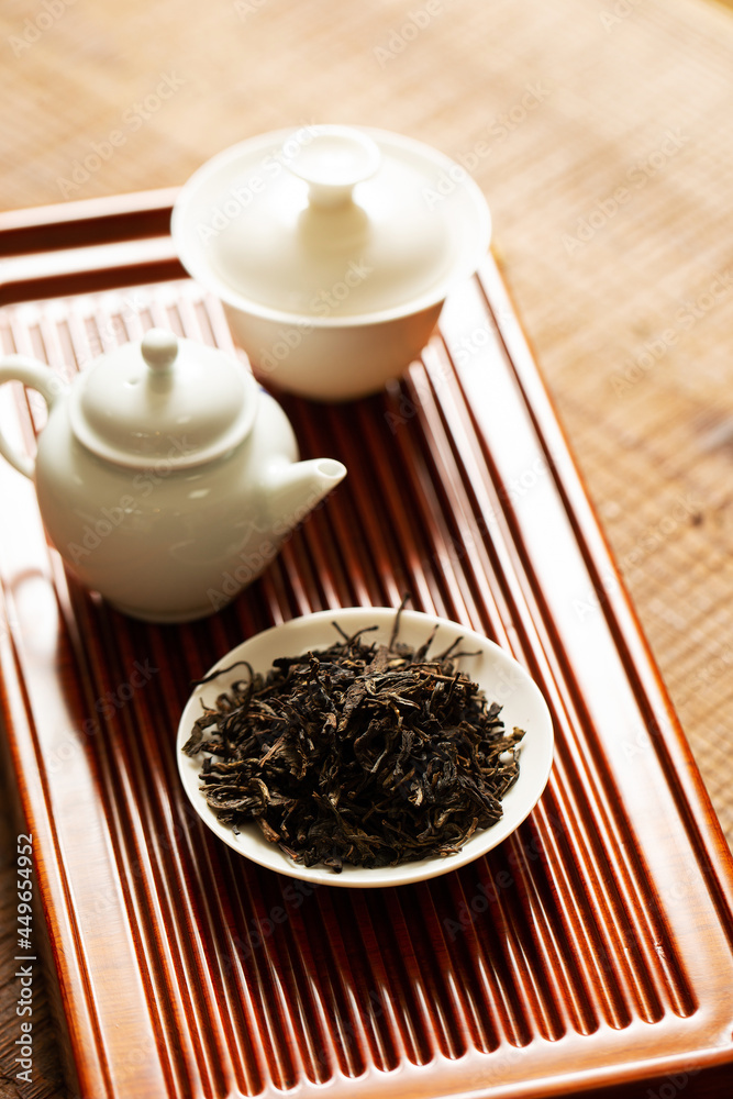 Sticker dried tea and pottery set on bamboo board