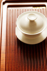 Porcelain green tea cup on bamboo board