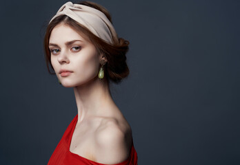 pretty woman with headband decoration red dress luxury dark background