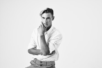 handsome man in shirt sitting on a chair fashion elegant style light background