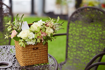 Roses and various flowers in a wooden basket