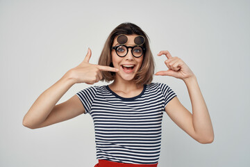 cheerful fashionable woman in striped t-shirt glasses posing summer