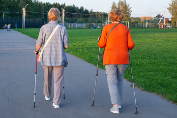 Nordic walking with sticks. Pensioners take care of their health.
