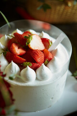 Fresh raw strawberries on a whipped cream cake