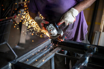 Metal processing in the workshop. Grinding metal.