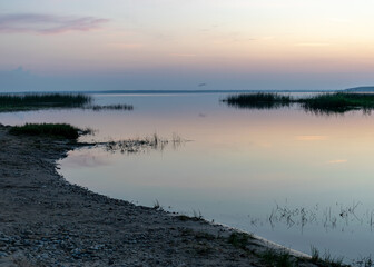 summer landscape on the shore of the lake at dawn, colors in the sky before sunrise, Lake Burtnieki, Latvia