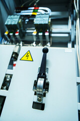 Switch in an industrial switchboard. Electrical equipment in an apartment building with safety inserts. Vertical photo. Close-up