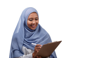 pretty asian muslim woman in hijab posing with clipboard isolated over white background