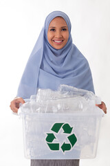 eco living and environment concept - happy smiling young asian muslim woman in hijab holding plastic garbage in plastic box isolated over white background