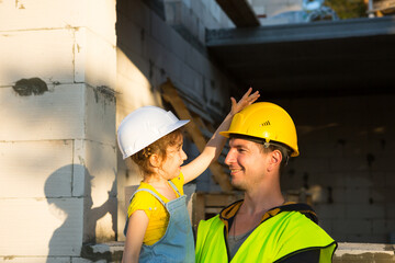 Dad and daughter are at construction site of their future home. The choice of the future profession...