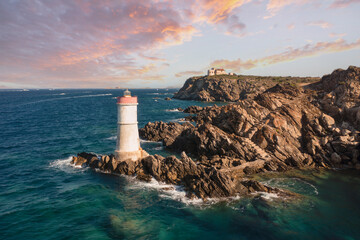 View from above, stunning aerial view of an old and beautiful lighthouse located on a rocky coast...